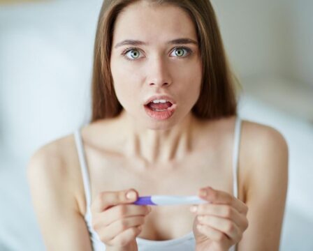 Portrait,Of,A,Young,Shocked,Woman,With,Pregnancy,Test